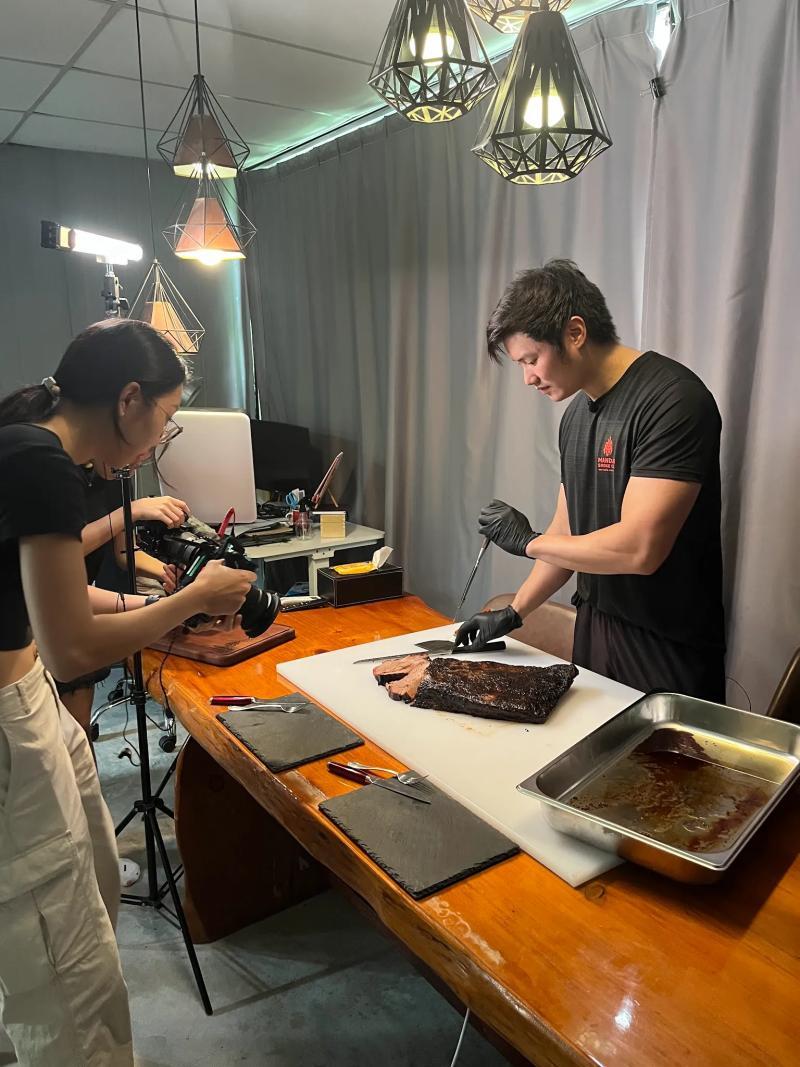 Royston Chan, founder of Mandai Smoke Co, holding a raw brisket ready for smoking