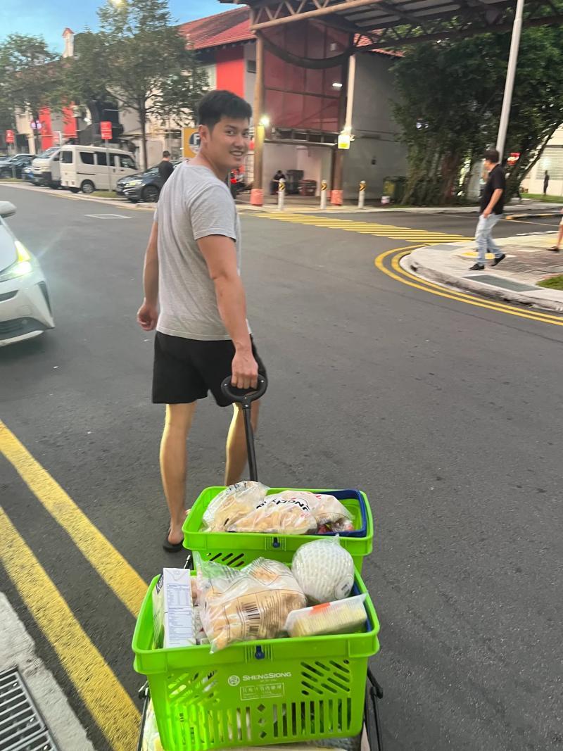 Royston Chan pulling shopping baskets loaded with ingredients for weekend smoking